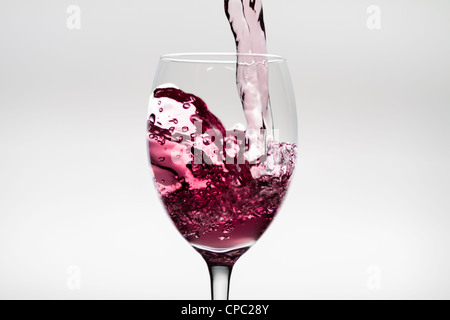 Flush of wine falling into a wineglass Stock Photo