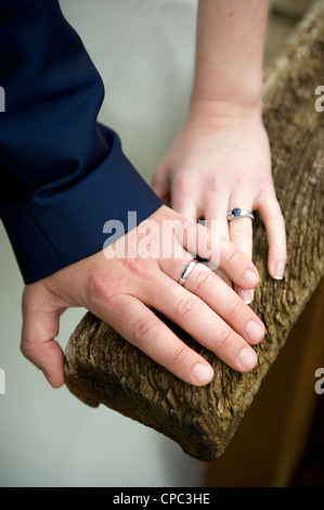 newly married couple's hands with their wedding rings Stock Photo