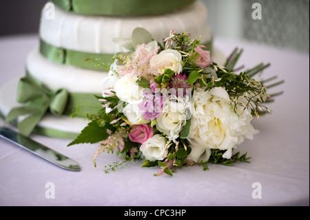 wedding bouquet displayed alongside the cake at a wedding Stock Photo