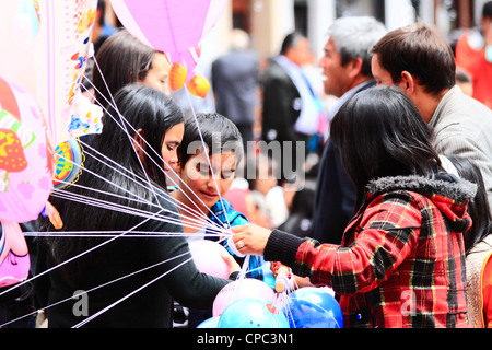 Working chld. A girl selling ballons in the street. Tunja, Boyacá, Andes, Colombia, South America Stock Photo