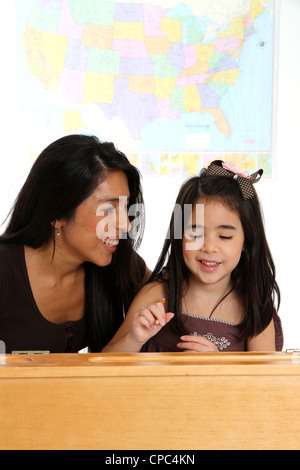 Elementary aged girl in her school classroom Stock Photo