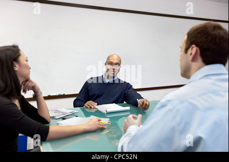 People having a meeting in a conference room. Stock Photo