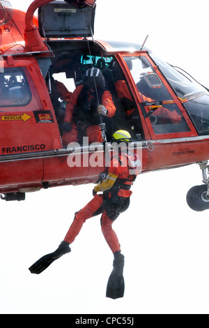A swimmer is winched from the waters of San Francisco Bay by a United States Coast Guard HH-65C Dolphin helicopter. Stock Photo