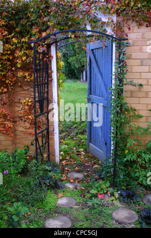 Garden gate, open door secret garden Stock Photo