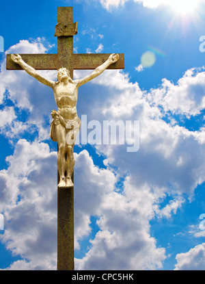 Statue of Jesus on cross with blue sky Stock Photo - Alamy
