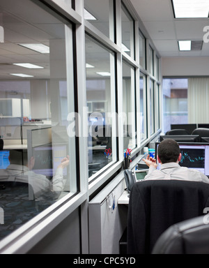 A man working at his desk in an office environment. Stock Photo