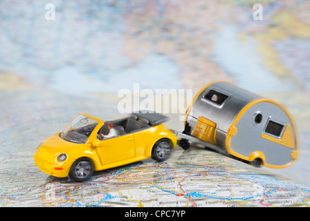 Model Car with camping trailer on a road map. Stock Photo