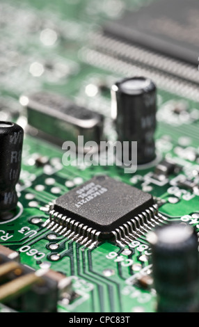 Detail of a computer circuit board with a focus on an integrated circuit. Stock Photo