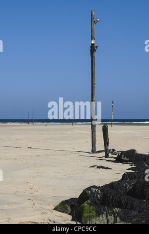 Lelant sands Cornwall Cornish beach in St Ives Bay navigation light poles for Hayle harbour low tide Stock Photo