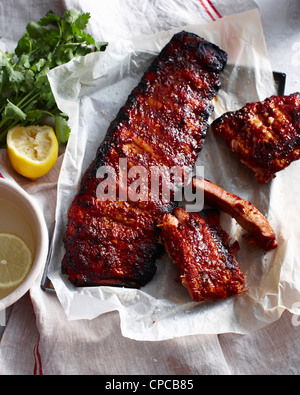 Rack of sticky pork ribs with lemon Stock Photo