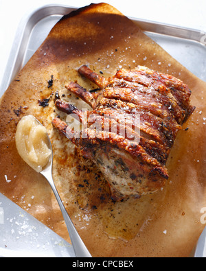 Platter of roast pork with applesauce Stock Photo