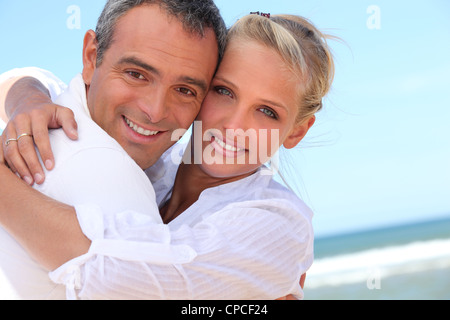 Embracing on the beach Stock Photo