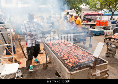 A man cooking on large barbecue Stock Photo