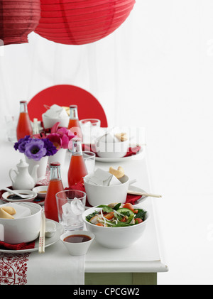 Table set with Chinese food and soda Stock Photo