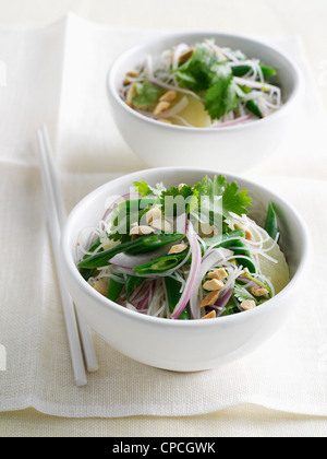 Bowls of noodles and veggies Stock Photo