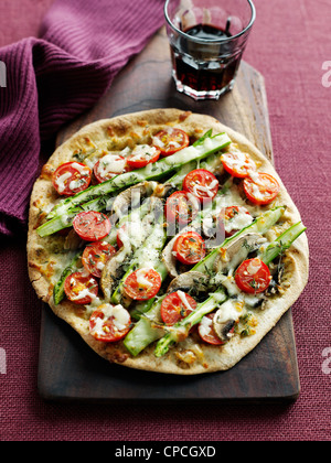 Plate of pizza with tomato and asparagus Stock Photo