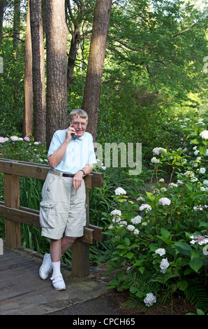 A retired man talking on his cell phone. Stock Photo