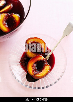 Bowl of stewed plums in wine Stock Photo