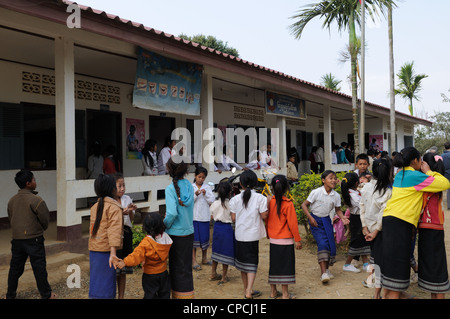 Lao school children during a presentation of books and stationary by tourists Ziemg Khuang Province Northern Laos Stock Photo