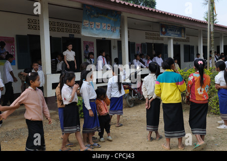 Lao school children during a presentation of books and stationary by tourists Ziemg Khuang Province Northern Laos Stock Photo