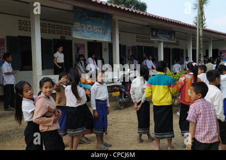 Lao school children during a presentation of books and stationary by tourists Ziemg Khuang Province Northern Laos Stock Photo