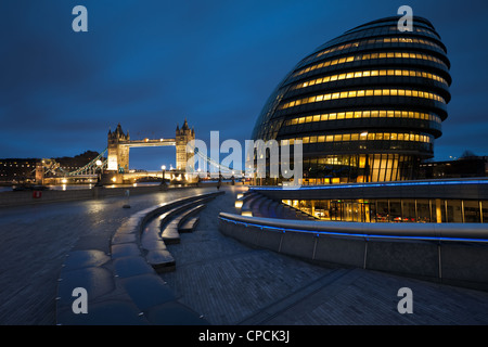 City Hall and Tower Bridge in London before dawn. Stock Photo