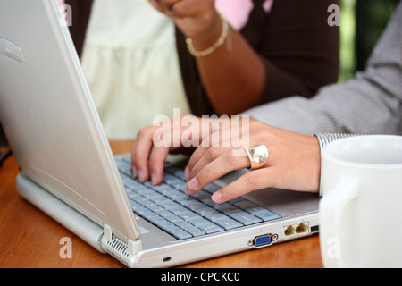 Two Women Working On A Computer Together Stock Photo