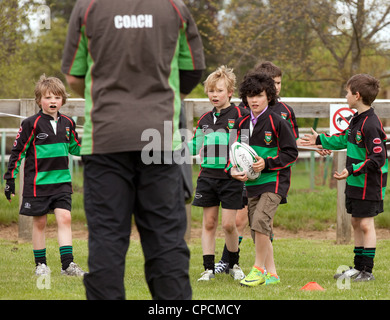 Rugby coach coaching children - Newmarket Juniors Club, Suffolk UK Stock Photo