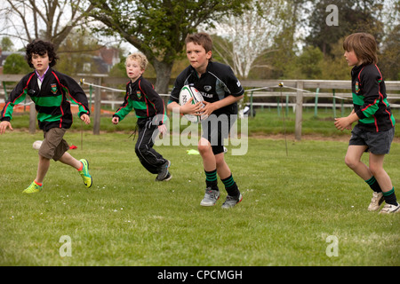 Junior boys in a rugby team playing a rugby match, Newmarket Suffolk UK Stock Photo