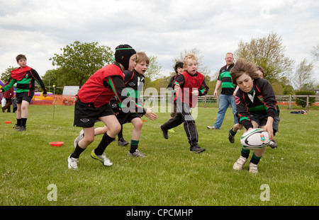 Child junior playing rugby and scoring a try, Newmarket Juniors, Suffolk UK Stock Photo