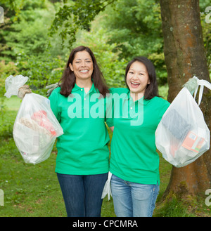 Gardeners picking up trash in park Stock Photo