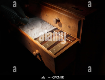 Gold bars in dresser drawer Stock Photo