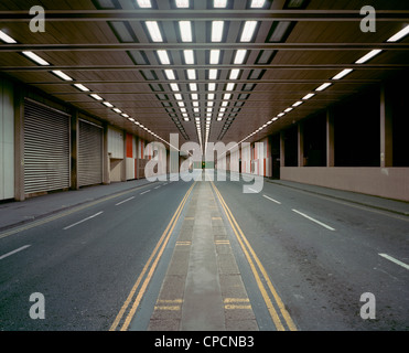 Illuminated road in parking structure Stock Photo