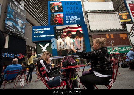 Tourists take photos in New York City's Times Square on the 10th anniversary of the 9-11 attack at the World Trade Center. Stock Photo