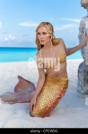 Young blond mermaid on the beach in Cancun, Mexico Stock Photo