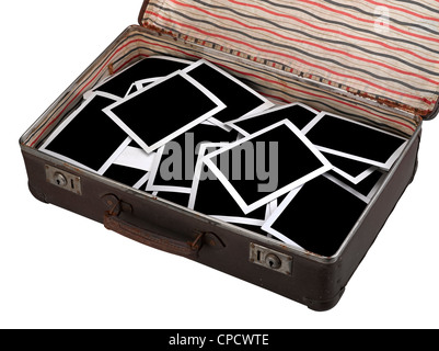 Old instant photos on antique brown suitcase isolated on white, path for pictures Stock Photo