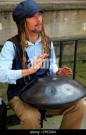 Young Male Street Musician playing a Hang Drum on the streets of Bath, UK Stock Photo