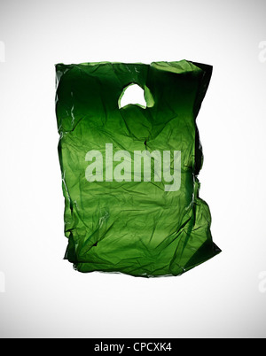 Crumpled green plastic bag on table Stock Photo