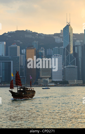 Chinese sailing junk on Victoria Harbour, the skyline of Central, Hong Kong Island beyond, Hong Kong, China, Asia Stock Photo