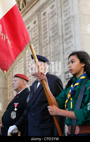 French Muslim girl scout and war veterans at the Arc de Triomphe, Paris, France, Europe Stock Photo