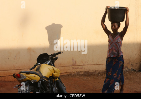 Woman carrying water, Lome, Togo, West Africa, Africa Stock Photo
