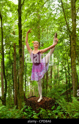 Caucasian ballerina dancing in forest Stock Photo