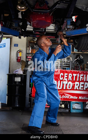 Black mechanic working on car Stock Photo