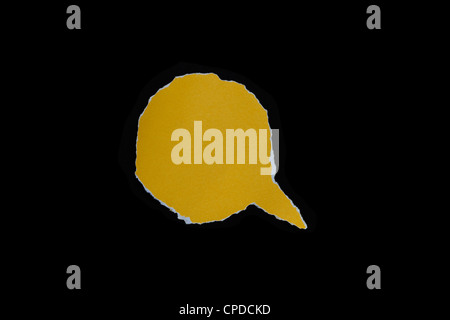 yellow paper tear bubble shape on dark background. Stock Photo