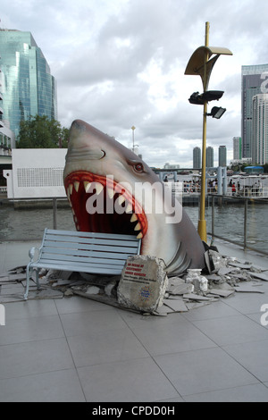 Giant white shark statue display near a bench in a shopping mall on Cha phraya river Stock Photo