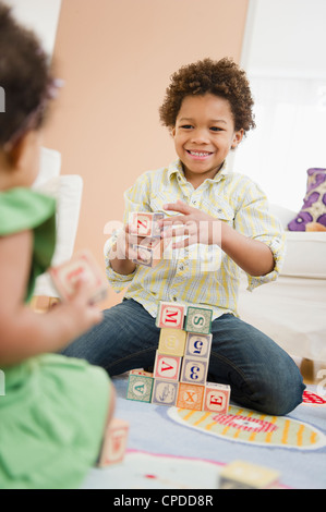 Black brother and sister playing with blocks Stock Photo
