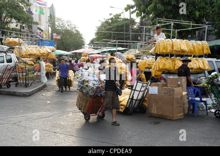 Worker working on street in Paklhong flower market , Bangkok Stock Photo