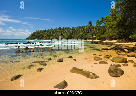 Western headland and surfing end of the south coast whale watch beach at Mirissa, near Matara, Southern Province, Sri Lanka Stock Photo