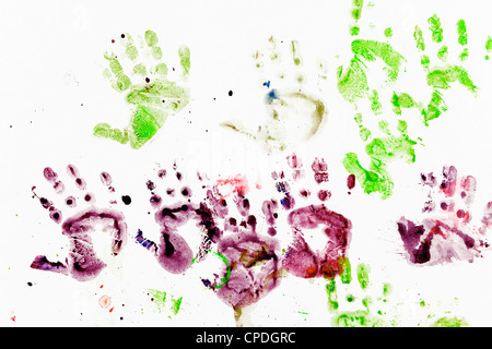 Harmonious child’s handprint picture with green and purple watercolors Stock Photo