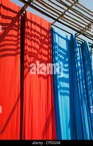 Freshly dyed fabric hanging to dry, Sari garment factory, Rajasthan, India, Asia Stock Photo